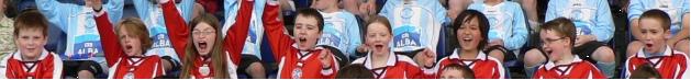 Edinburgh shinty youth team members raise their arms in celebration